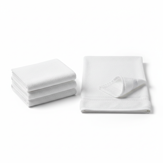 White cotton terry hotel hand towel shown in compact folded stack and lengthwise fold displaying dobby border with corner folded back showing dense terry loop pile texture on white background, commercial hospitality bathroom hand towel