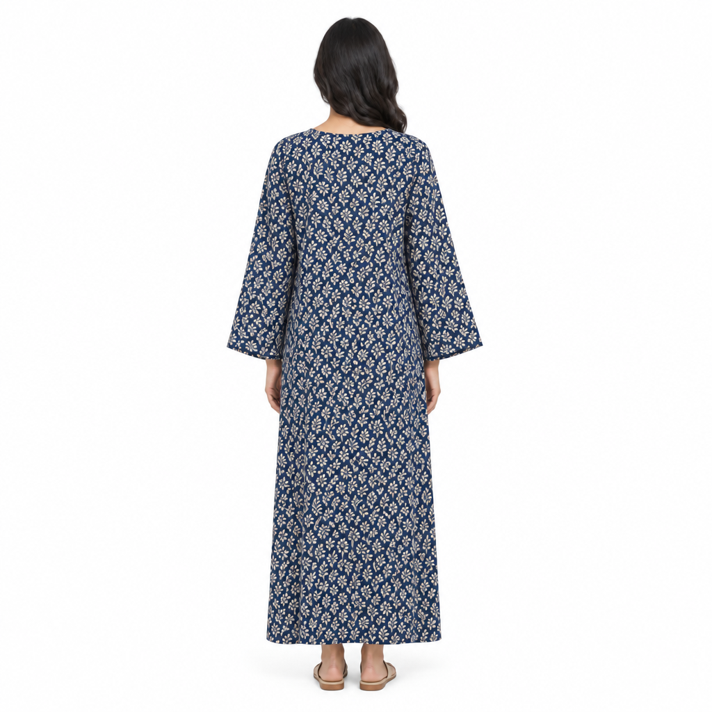 Back view of model wearing the full-length navy botanical print kaftan dress on a white background