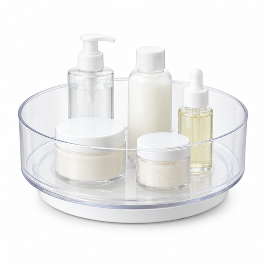 Rotating storage organizer, clear round lazy susan turntable with small bottles on white background