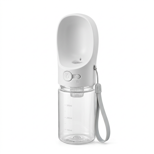 Portable pet water bottle with transparent reservoir, integrated curved drinking trough, dispensing button, and wrist strap on pure white background