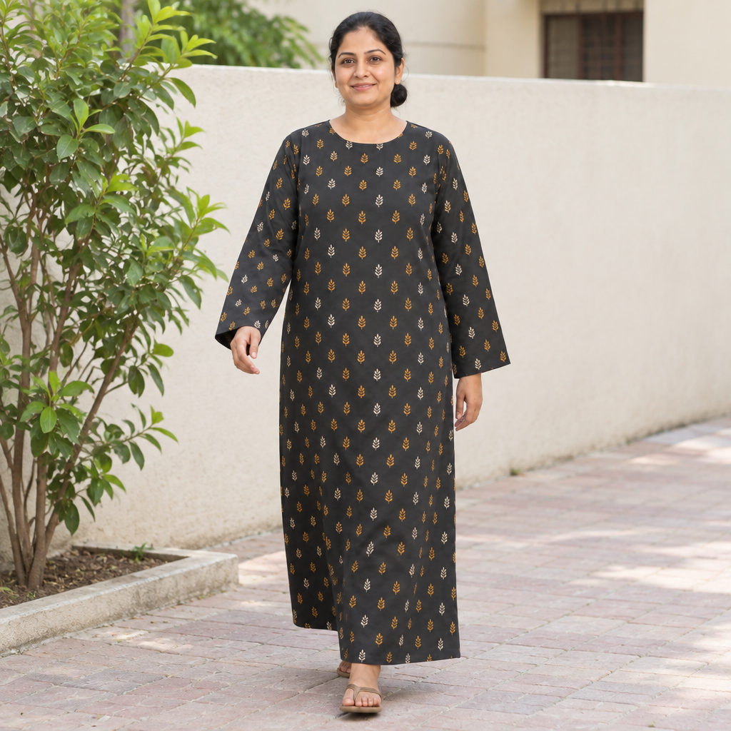 Mature model walking outdoors in a charcoal printed full-length kaftan abaya with loose long sleeves