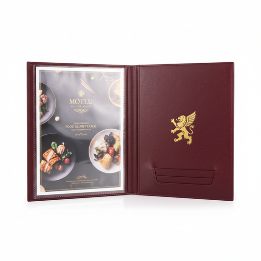 Deep burgundy PU leather hotel room service menu folder open showing interior clear plastic sleeve with food and beverage menu page and card slot with gold embossed hotel logo on front cover on white background, premium hospitality in-room dining menu presentation