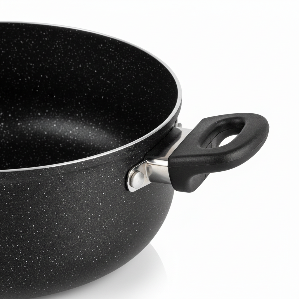 Macro detail of riveted stay-cool side handle, flared rim, and black granite non-stick coating
