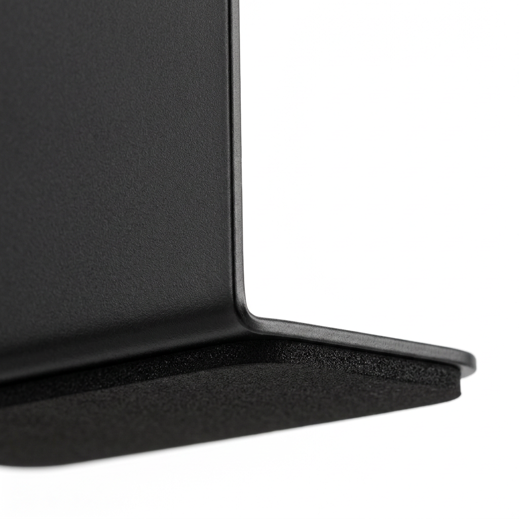 Detail close-up of metal bookend showing 90-degree bent corner and non-slip base pad on white background