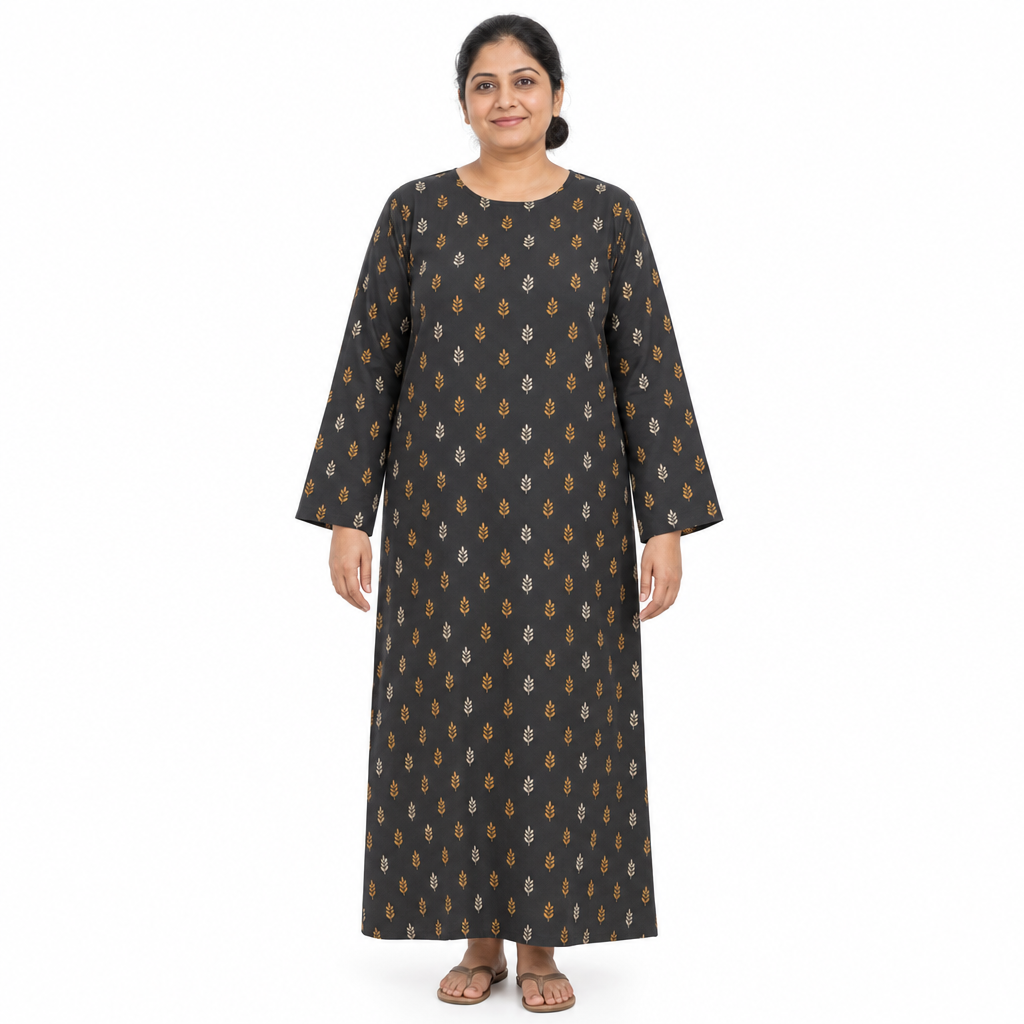 Mature model wearing a charcoal full-length long-sleeve kaftan abaya with small ochre and ivory leaf print on a white background