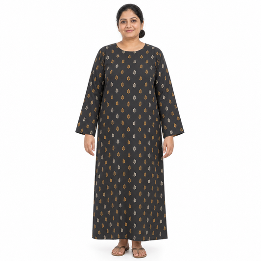 Mature model wearing a charcoal full-length long-sleeve kaftan abaya with small ochre and ivory leaf print on a white background