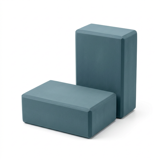 Rectangular foam yoga block used as a support accessory for yoga and stretching.