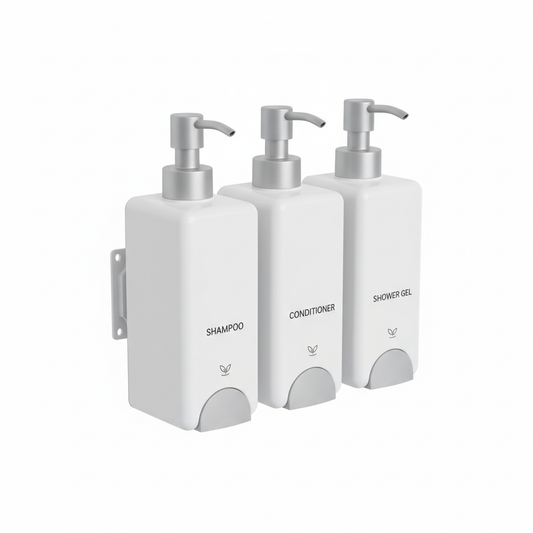 Three matching white wall-mounted refillable hotel dispensers for shampoo conditioner and shower gel on white background, coordinated hospitality amenity set
