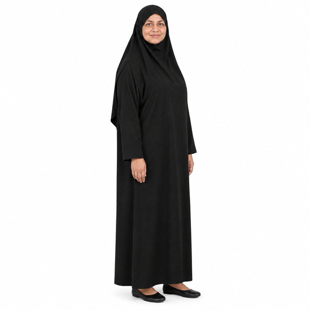Angled full-length view of a black jilbab dress showing the head covering drape and loose straight body on white