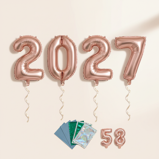 Four champagne rose gold number foil balloons arranged as 2027 with ribbons and secondary color and digit samples on a warm off-white background