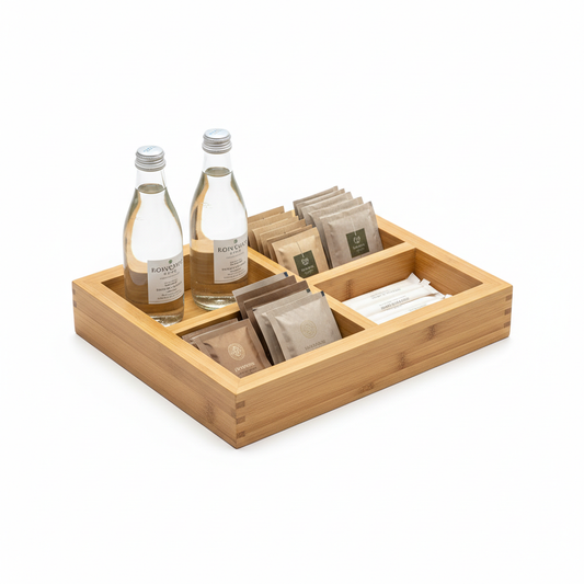 Hotel multi-compartment bamboo amenity tray organizing tea and coffee on white background