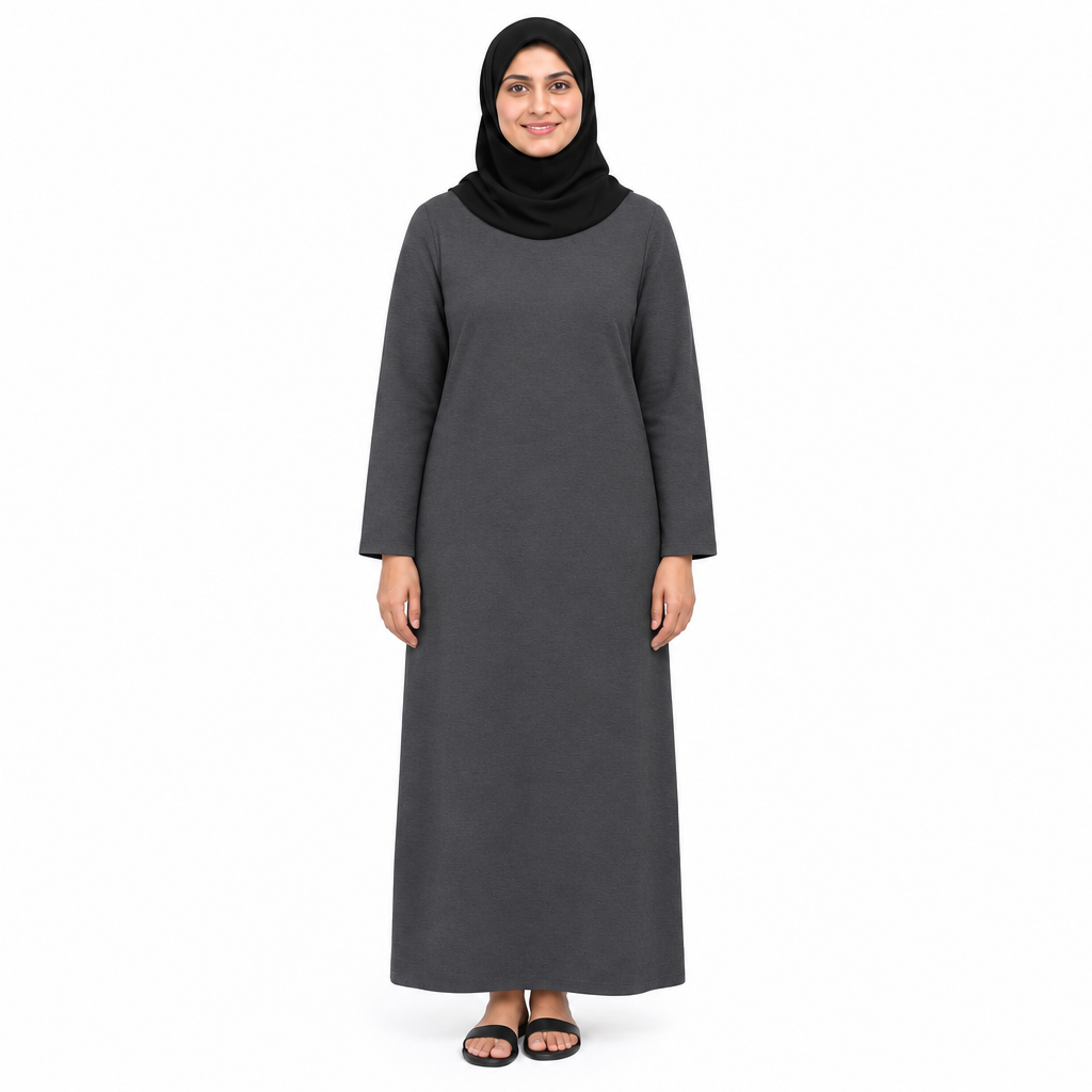 Model in a plain charcoal grey one-piece modest dress with long sleeves and relaxed full-length fit, front view on white
