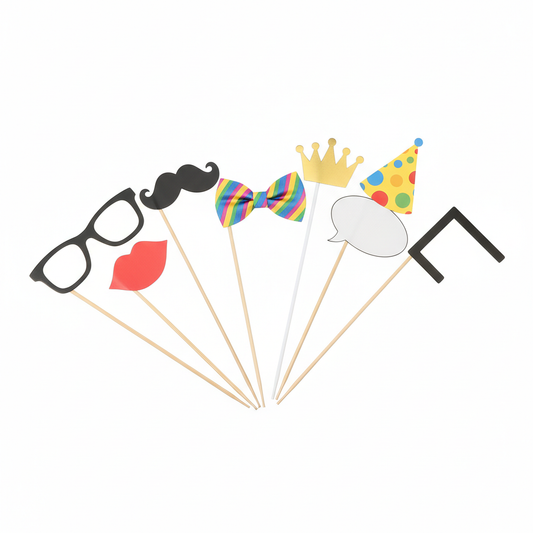 Assorted handheld party photo booth props including glasses, moustache, lips, bow tie, crown and party hat on a pure white background.