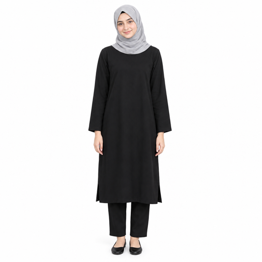 Model in a grey hijab wearing a plain black loose long tunic dress to mid-calf, styled over black trousers, on a white background