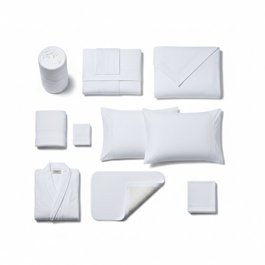 Complete coordinated white hotel linen supply set flat lay showing bed sheet stack, duvet cover, pillowcases, bath towel, hand towel, face towel, bathrobe, bath mat and restaurant napkins all with consistent dobby border in organized grid layout on white background, professional hospitality procurement textile package