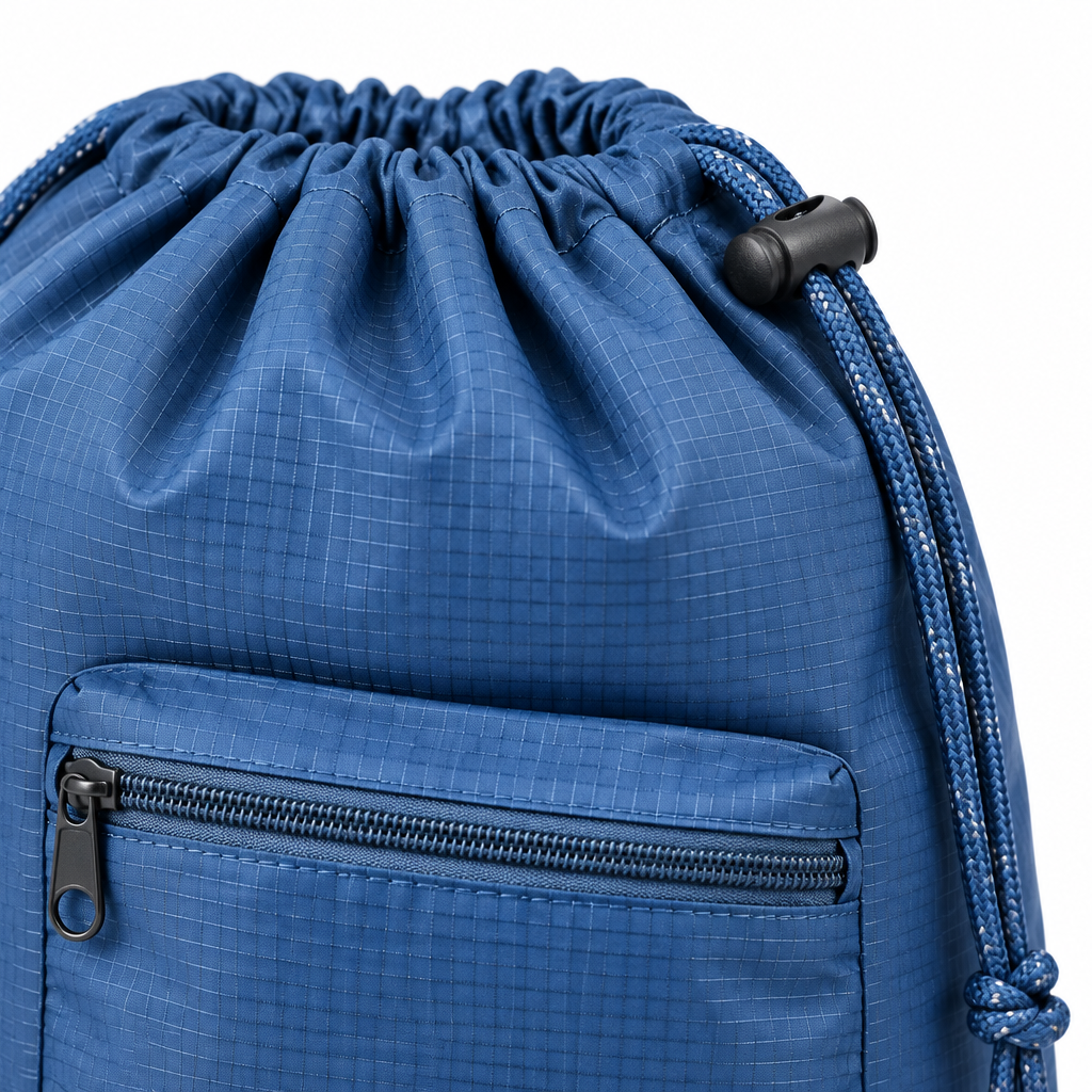 Close-up of the travel laundry bag drawstring cinch closure, toggle lock, and front zip pocket