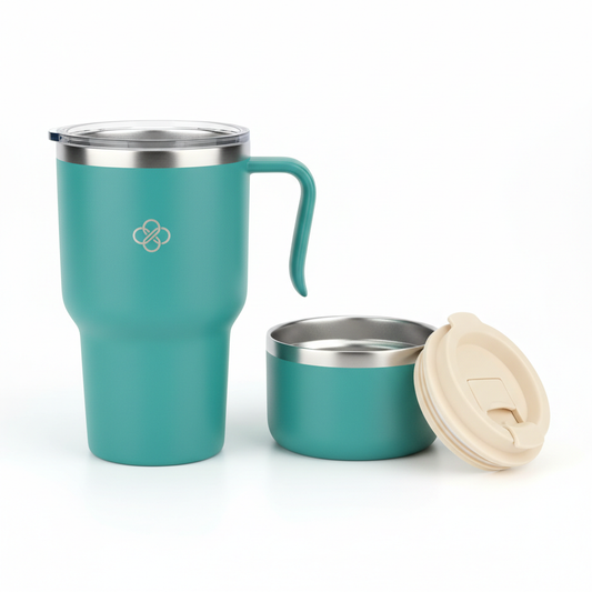 Matte teal stainless steel hotel travel cup with cream sliding lid, attached carry handle, silicone seal and non-slip base on white background
