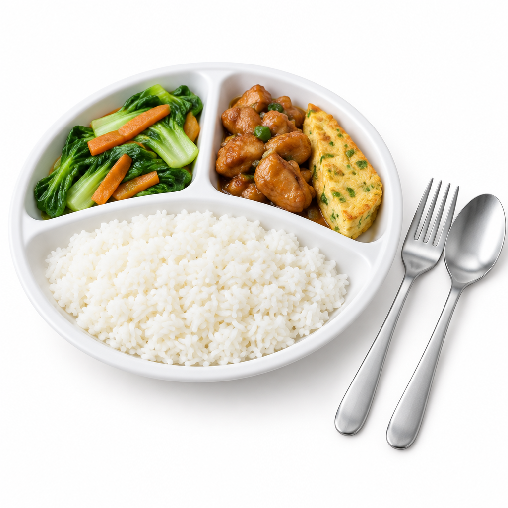 Round divided white melamine compartment plate with separate portions of steamed rice, stir-fried vegetables, and savory meat alongside fork and spoon on a seamless pure white background