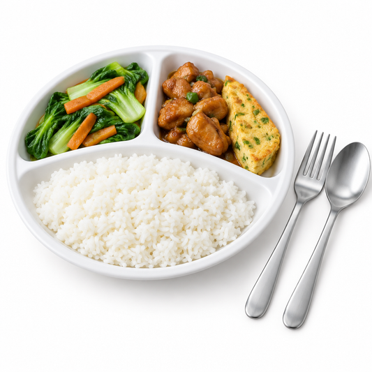 Round divided white melamine compartment plate with separate portions of steamed rice, stir-fried vegetables, and savory meat alongside fork and spoon on a seamless pure white background