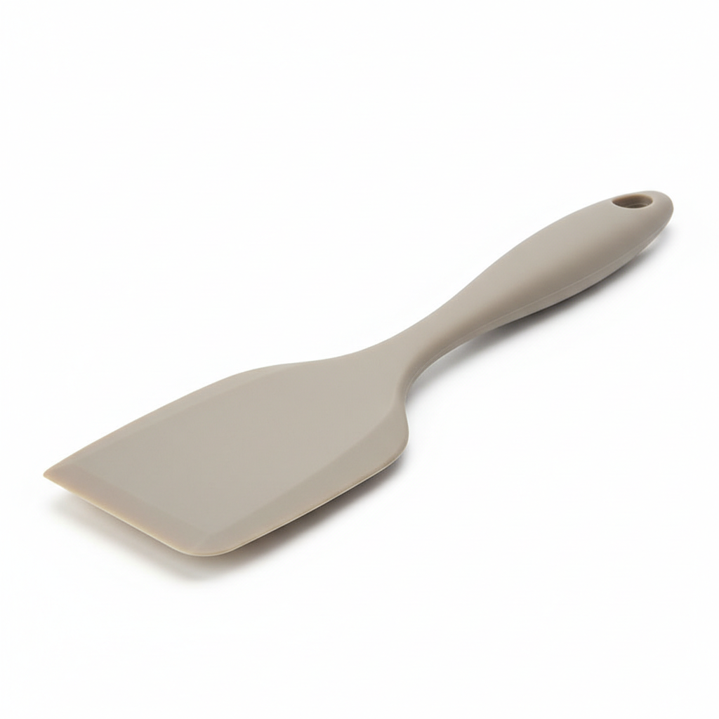 Seamless food-grade silicone turner spatula with thin beveled edge on pure white background