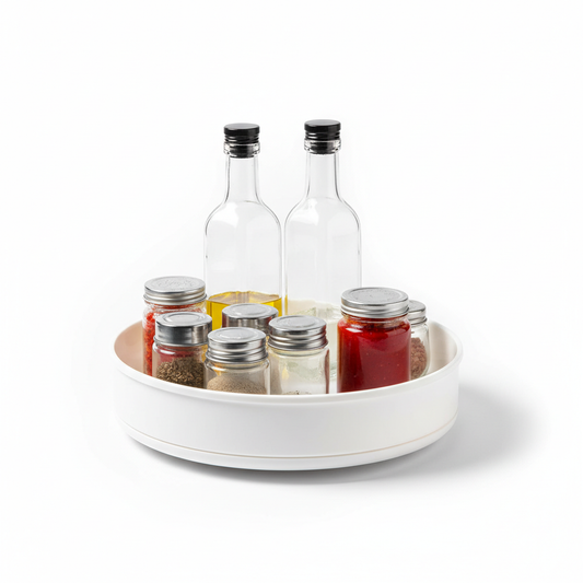 Round rotating kitchen storage organizer turntable holding spice jars and sauce bottles on pure white background