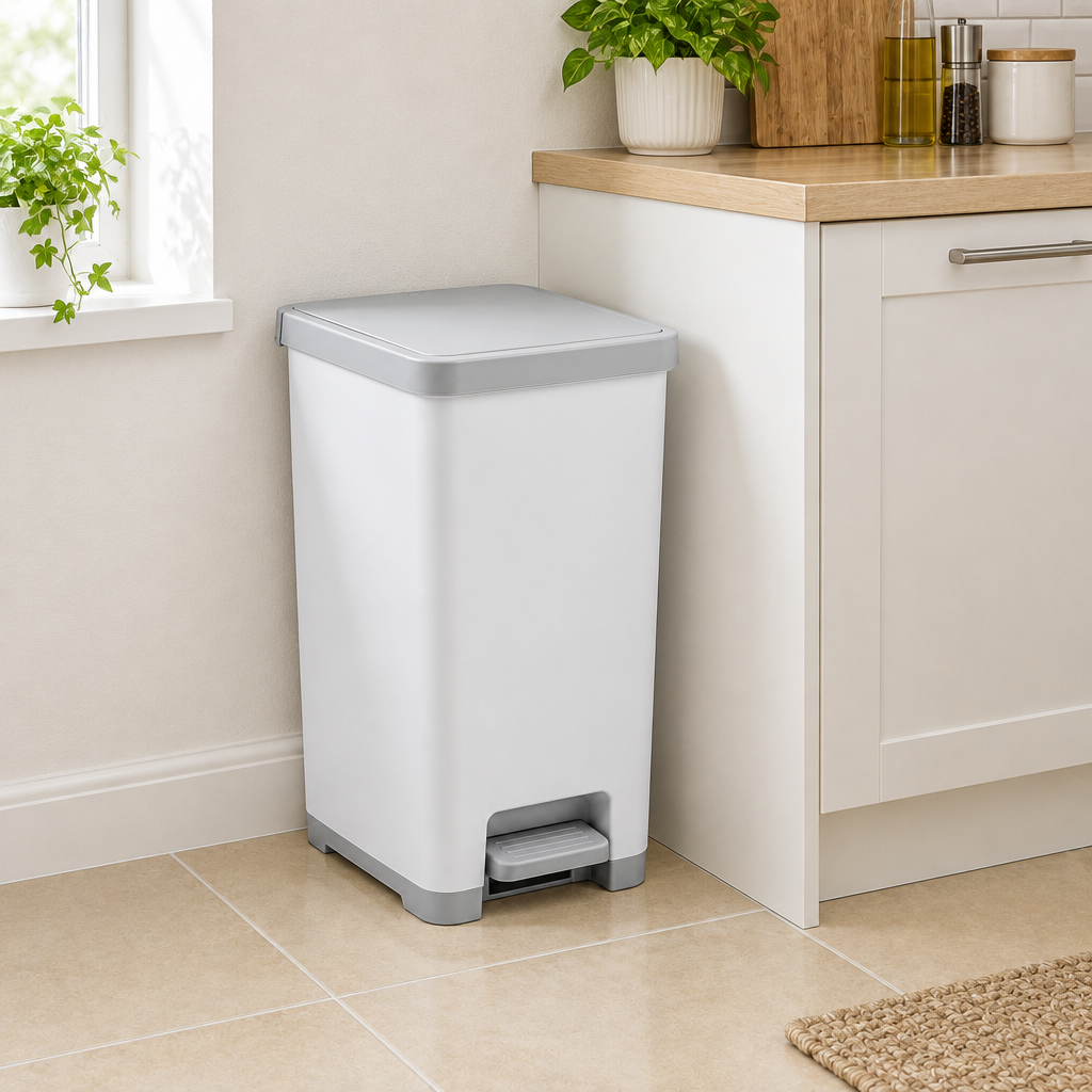Pedal trash bin in practical apartment kitchen corner beside cabinet