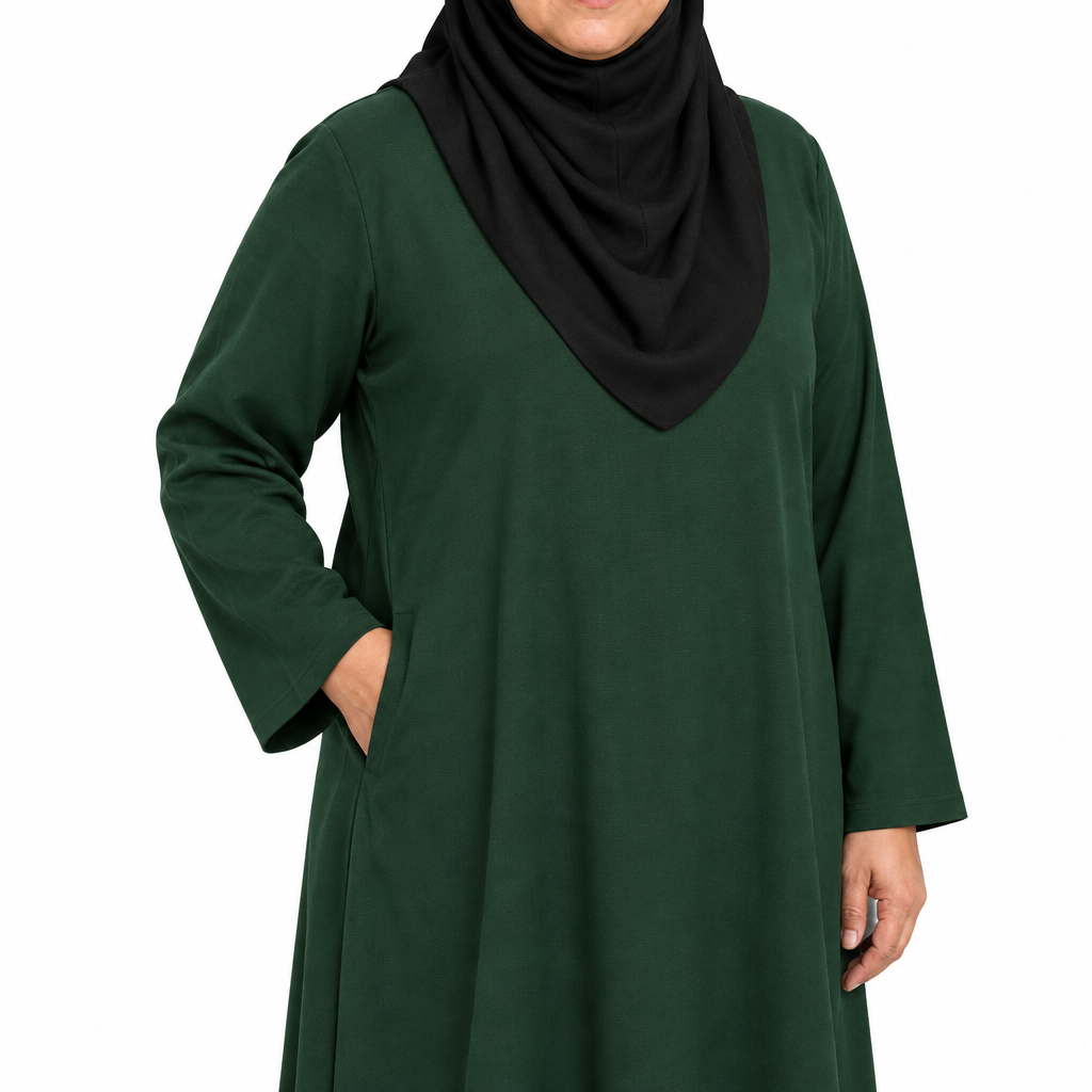 Close-up of a hand placed inside the side seam pocket of a dark green solid abaya