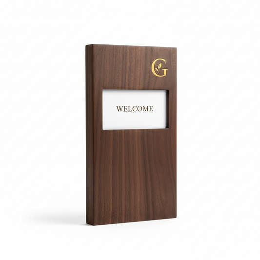 Elegant rectangular dark walnut wood hotel welcome board with white welcome message card and subtle gold logo engraving standing upright on white background, custom hospitality guestroom desk sign