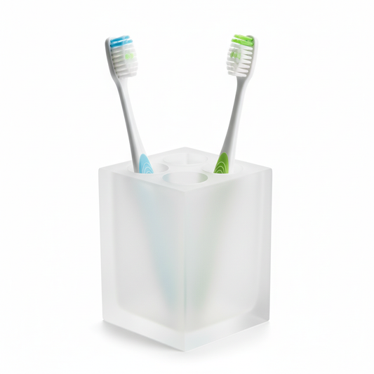 Square frosted acrylic hotel toothbrush holder with four slots and two toothbrushes inside on white background, compact guestroom bathroom vanity accessory