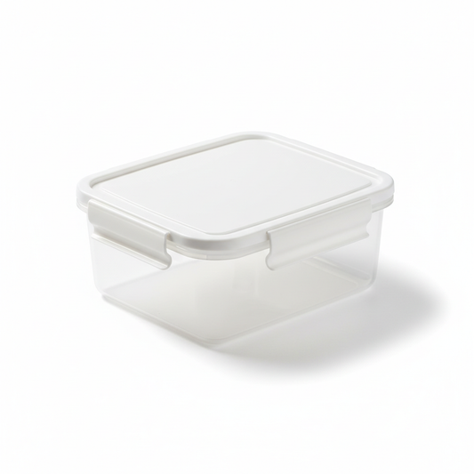 Rectangular clear food storage box with white snap lid on pure white background