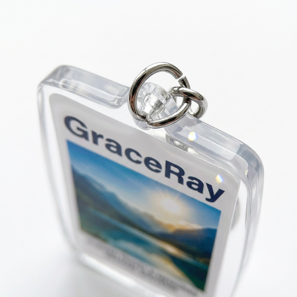 Detail close-up of acrylic photo keychain showing laser-polished edges and double-sided print sandwich on white background