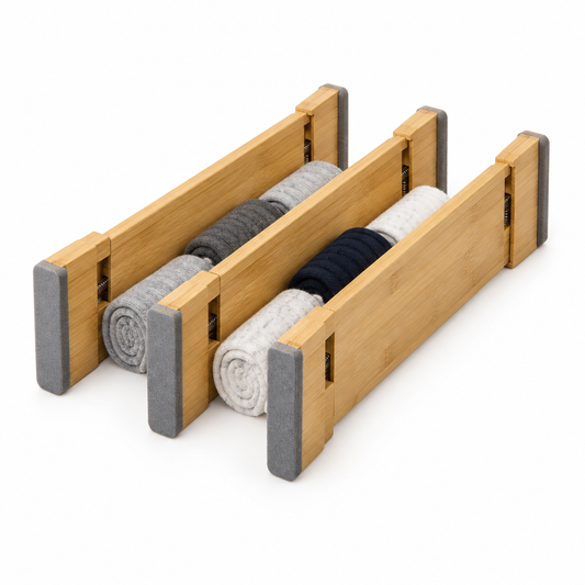 Adjustable drawer dividers in bamboo with foam end pads, three standing with rolled socks between them on white background