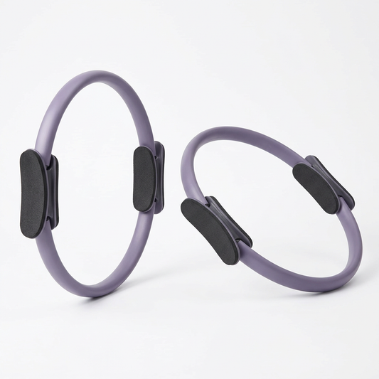 Circular Pilates resistance ring with padded handles for fitness exercises.