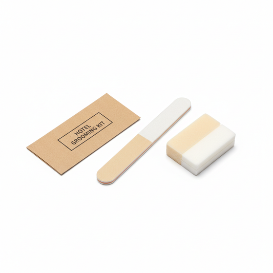 Hotel grooming kit with double-sided EVA nail file and nail buffer block beside kraft paper packaging sleeve on white background, compact guest personal care amenity