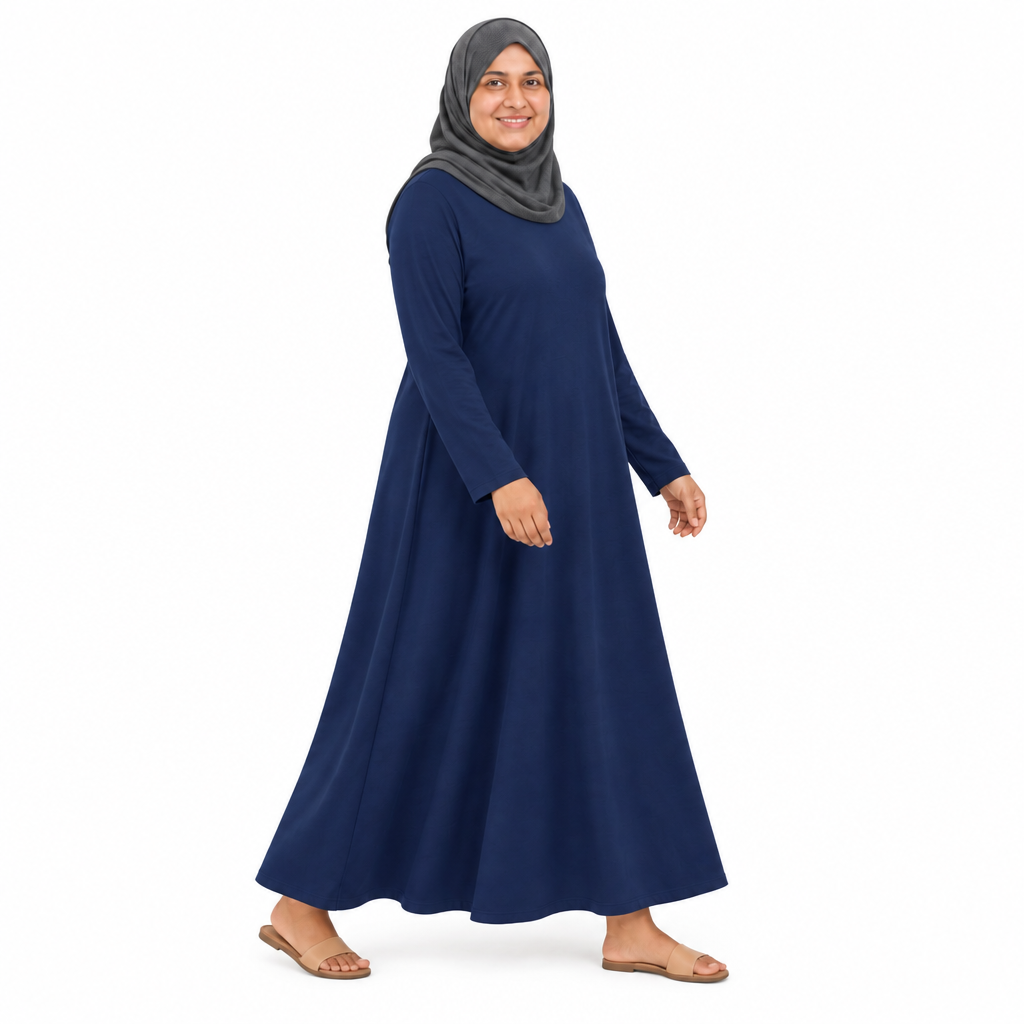 Side view of a navy loose-fit maxi dress mid-step showing the relaxed A-line skirt and full length on white