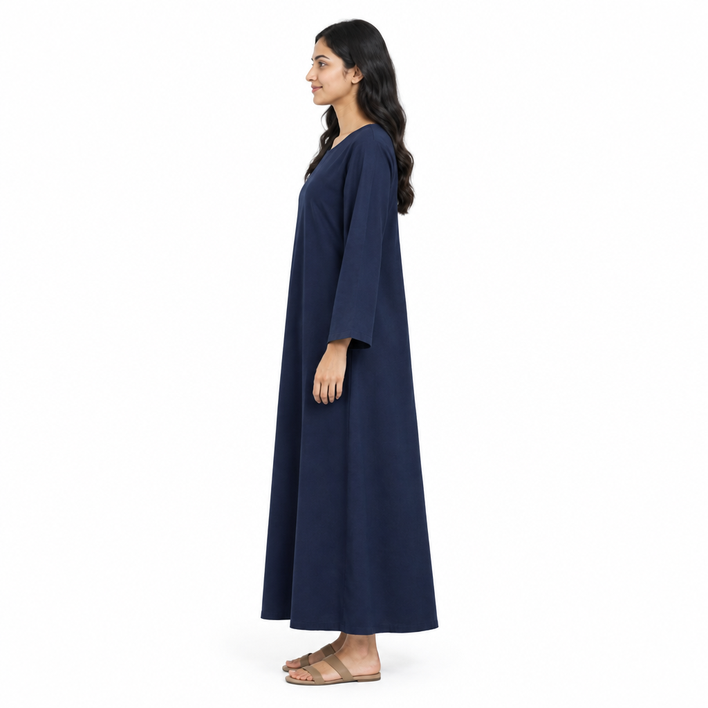 Side profile of model wearing the plain navy full-length kaftan dress showing its loose side silhouette and sleeve