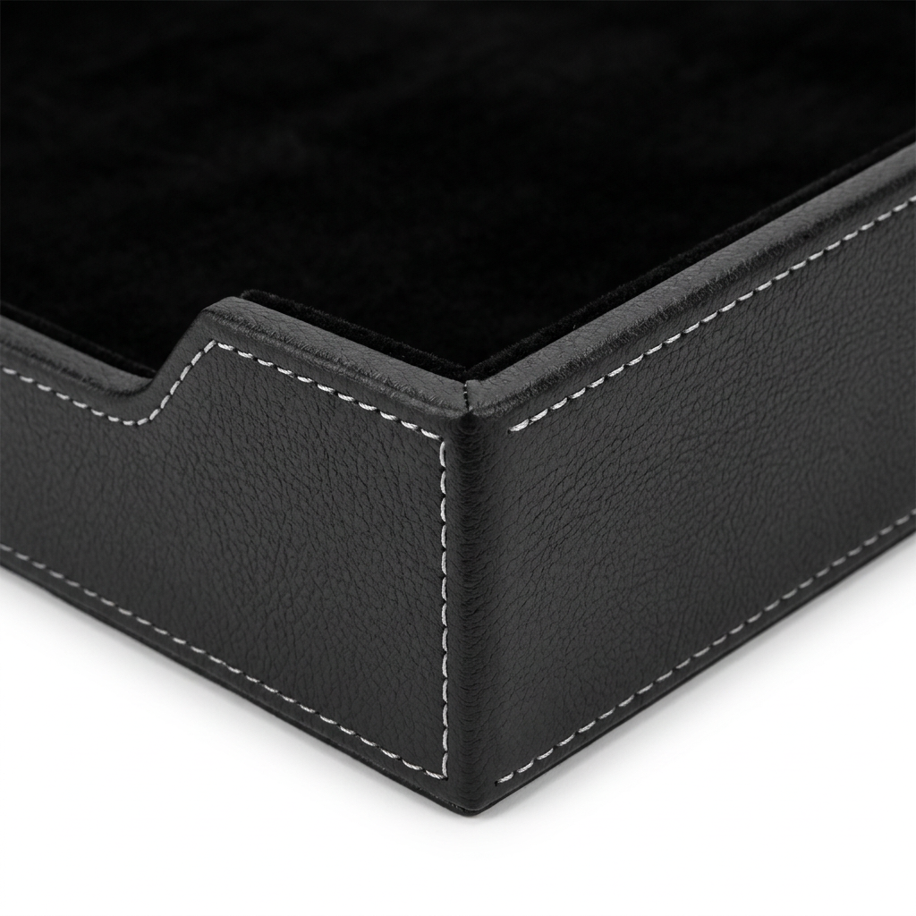 Detail close-up of document tray showing leather texture, white saddle stitching, and velvet lining on white background