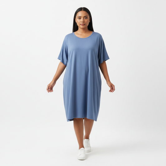 Indonesian woman dusty blue loose fit dress standing