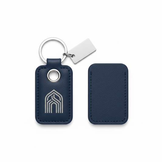Navy PU leather hotel keychain with rounded stitched fob, reinforced eyelet, connector loop, silver split ring and blank charm on white background