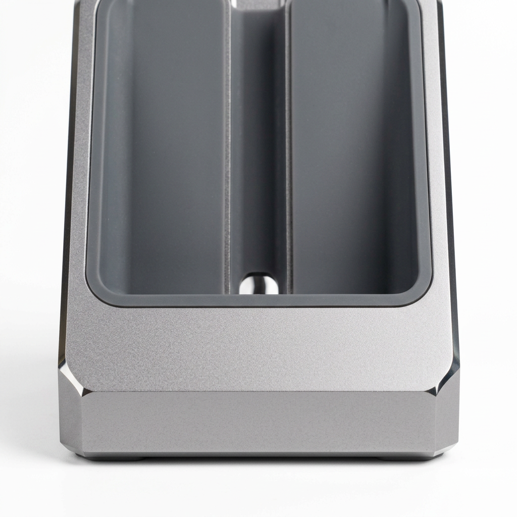Detail close-up of phone dock showing CNC diamond-cut chamfered bevel and silicone slot lining on white background