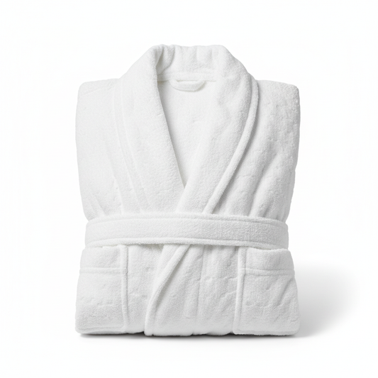 White cotton terry hotel bathrobe folded flat showing dense absorbent terry loop pile texture with shawl collar belt ties and two front pockets on white background, 350-500 GSM commercial hospitality guestroom spa robe