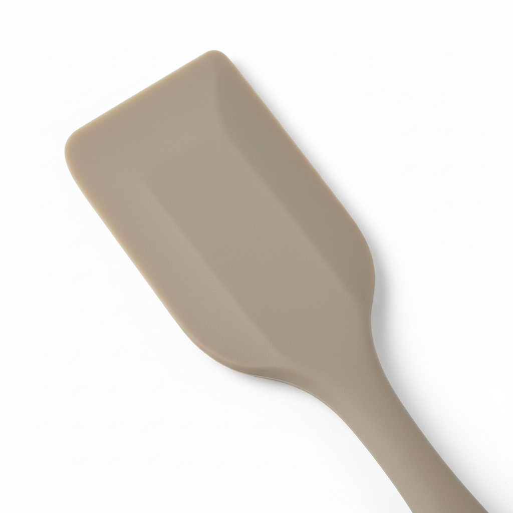 Macro detail of beveled silicone scraping blade and internal stainless steel core ridge