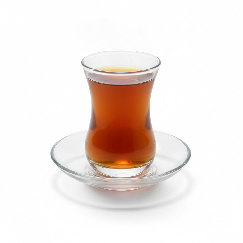 Traditional clear Arabic tea glass with amber tea on matching saucer on pure white background