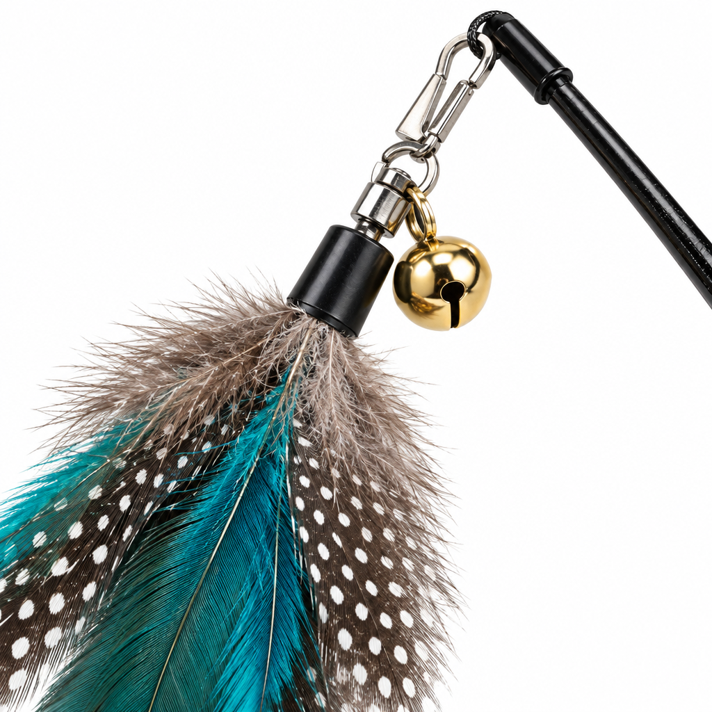 Macro close-up detail of metal swivel clasp connector, chime bell, and natural feather filaments on cat wand