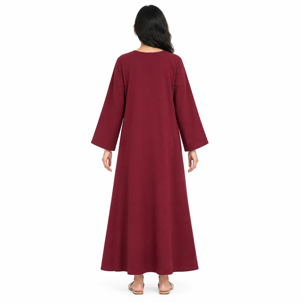 Back view of model in a full-length plain burgundy loose long-sleeve kaftan dress on a white background