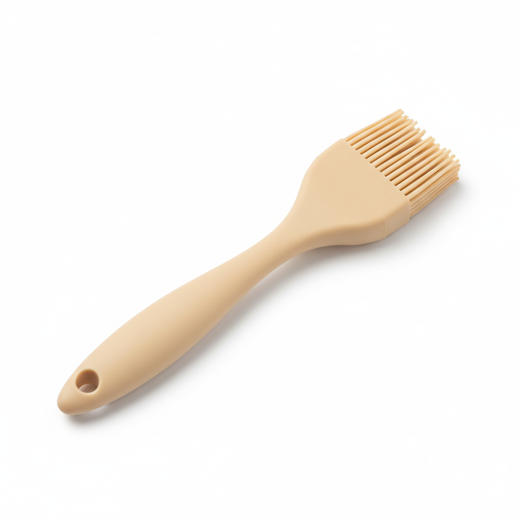 Warm beige one-piece silicone basting brush with flexible bristles on pure white background