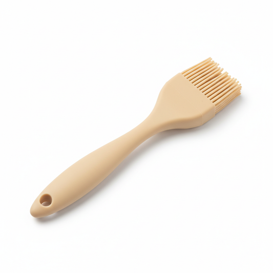 Warm beige one-piece silicone basting brush with flexible bristles on pure white background