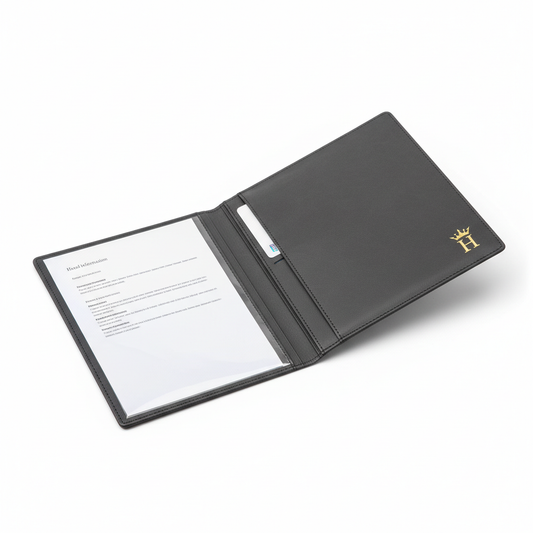 Dark charcoal grey PU leather hotel guest directory folder open showing interior with clear document pocket holding hotel information sheet and card slot, gold embossed logo on front cover on white background, premium hospitality guestroom in-room information organizer